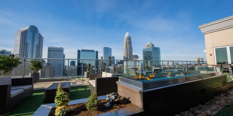 Fahrenheit Charlotte's West Patio 2 features a rooftop seating area with a long fire pit and panoramic views of the Charlotte skyline.