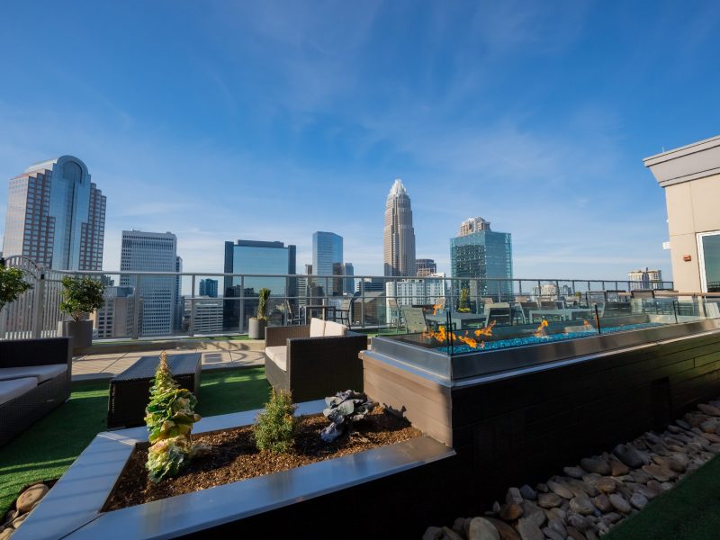 The lounge opens up to our rooftop patio, which features linear fire pits and breathtaking views of Uptown Charlotte.